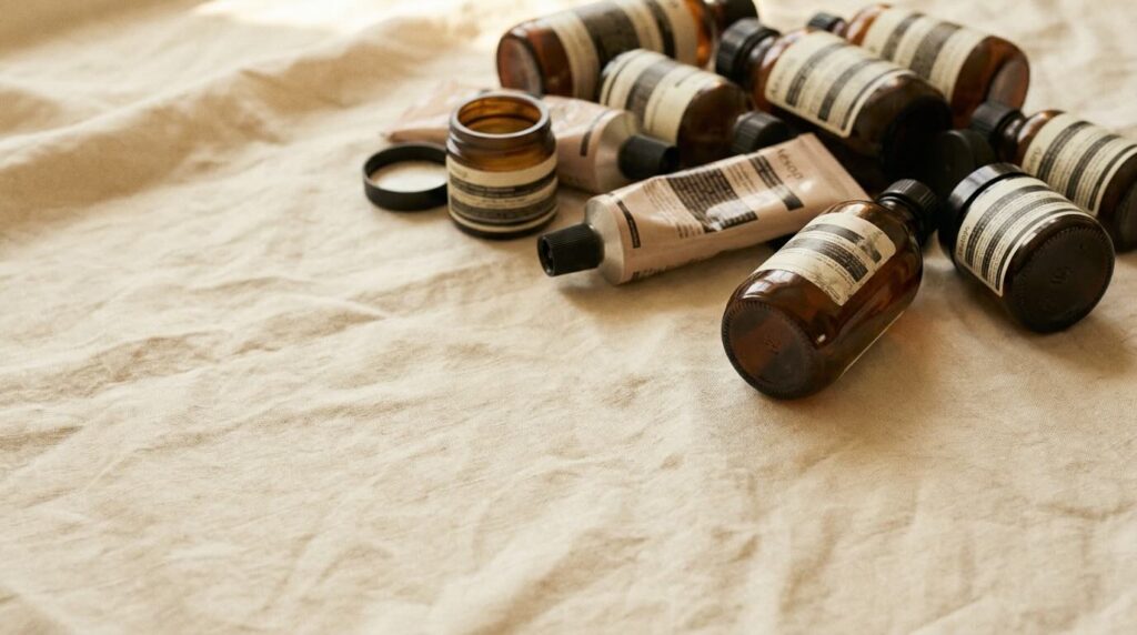 Rejected glass skin products pushed aside on warm linen after testing